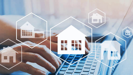 Photo of a Laptop and house graphic elements in white